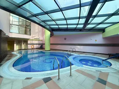 a large swimming pool in a building with a ceiling at GuestReady - 3BR | Luxury High-Rise Escape in Dubai