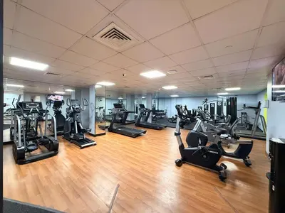 a gym with several treadmills and exercise bikes at GuestReady - 3BR | Luxury High-Rise Escape in Dubai
