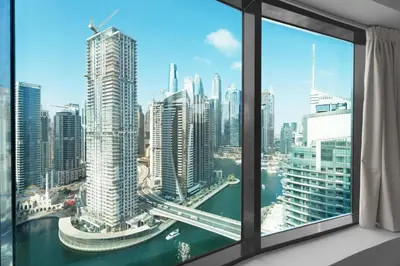 a view of a city from a window at GuestReady - 3BR | Luxury High-Rise Escape in Dubai