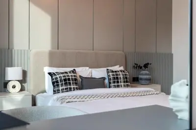 a bed with black and white pillows on it at Luxury 1BR with Private Pool & Balcony in Dubai