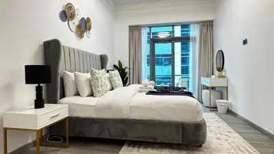 a bedroom with a large bed and a large window at 4BDR Duplex Apartment 8 Guests in Dubai