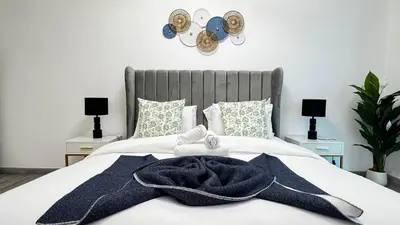 a bedroom with a bed with blue towels on it at 4BDR Duplex Apartment 8 Guests in Dubai