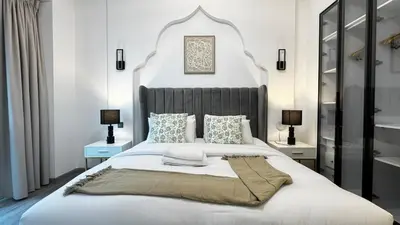 a bedroom with a large bed with a large headboard at 4BDR Duplex Apartment 8 Guests in Dubai