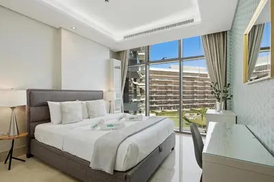 a bedroom with a large bed and a large window at Stunning 2 Bedroom in Palm with private beach in Dubai
