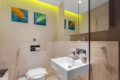 a bathroom with a sink and a toilet at Stunning 2 Bedroom in Palm with private beach in Dubai