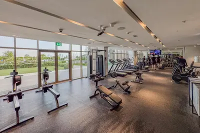 a gym with rows of exercise bikes and treadmills at Stunning 2 Bedroom in Palm with private beach in Dubai