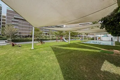 a large white canopy over a lawn with a pool at Stunning 2 Bedroom in Palm with private beach in Dubai