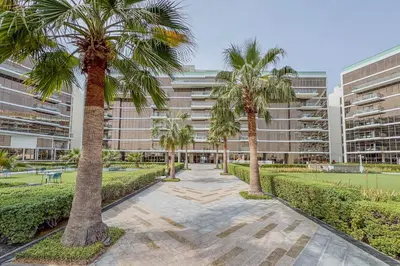 a row of palm trees in front of a building at Stunning 2 Bedroom in Palm with private beach in Dubai