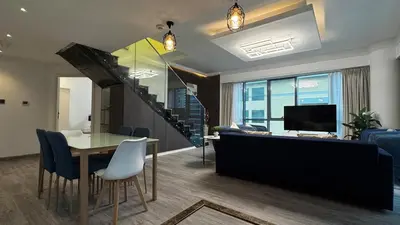 a living room with a table and a dining room at 3BDR Duplex Apartment with Large Family Living Room in Dubai