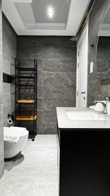 a bathroom with a white toilet and a sink at 3BDR Duplex Apartment with Large Family Living Room in Dubai