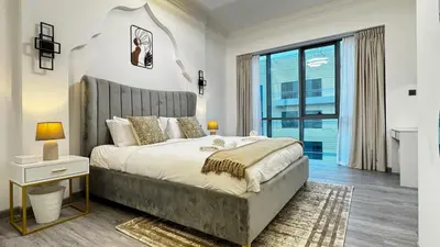 a bedroom with a large bed and a large window at 3BDR Duplex Apartment with Large Family Living Room in Dubai