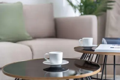 two coffee tables in a living room with a couch at Silkhaus Studio Burj Daman with Burj Khalifa View in Dubai