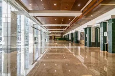 an empty hallway in a building with glass windows at Silkhaus Studio Burj Daman with Burj Khalifa View in Dubai