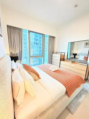 a bedroom with a large bed and a large window at Oshima Grande Downtown 1BR Burj Khalifa in Dubai