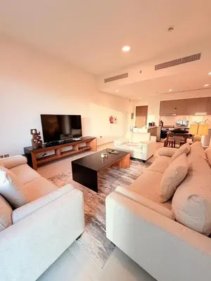 a living room with two couches and a flat screen tv at Oshima Grande Downtown 1BR Burj Khalifa in Dubai