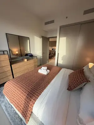 a bedroom with a large bed and a large television at Oshima Grande Downtown 1BR Burj Khalifa in Dubai