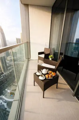 a balcony with a tray of food on a table at Oshima Grande Downtown 1BR Burj Khalifa in Dubai