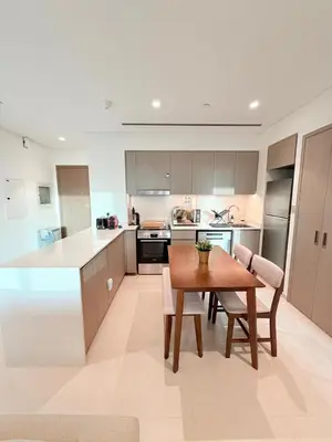 a kitchen with a wooden table and a dining room at Oshima Grande Downtown 1BR Burj Khalifa in Dubai