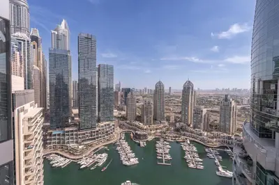 a view of a city with boats in a harbor at Elegant 1BR LIV Marina Dubai World-Class Amenities in Dubai
