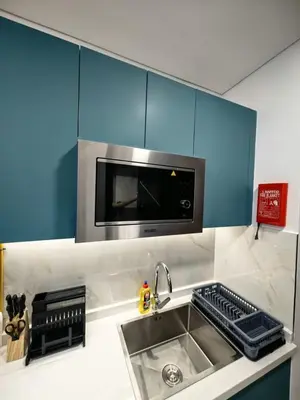 a kitchen with a sink and a microwave at Modern Studio in Opalz - Ideal for Work & Leisure in Dubai