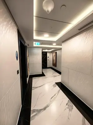 a lobby with a hallway with marble floors and a ceiling at Modern Studio in Opalz - Ideal for Work & Leisure in Dubai