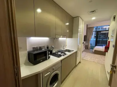 a kitchen with a sink and a microwave at Quiet Studio in Azizi 18-Ideal for Work & Leisure in Dubai