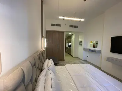 a hotel room with a bed and a television at Quiet Studio in Azizi 18-Ideal for Work & Leisure in Dubai