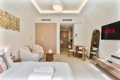 a bedroom with a bed and a living room at Chic Studio at Azizi Riviera Near Downtown Dubai in Dubai