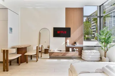 a hotel lobby with a waiting area with a sign that reads night at Chic Studio at Azizi Riviera Near Downtown Dubai in Dubai