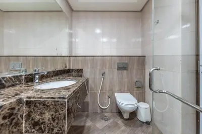 a bathroom with a sink and a toilet at HAVN - Studio in Botanica, JVC in Dubai