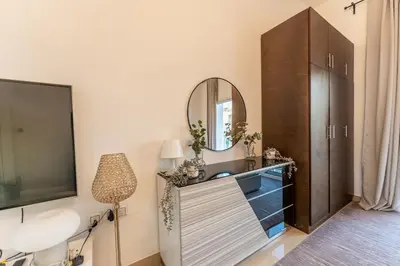 a bathroom with a sink and a mirror at HAVN - Studio in Botanica, JVC in Dubai