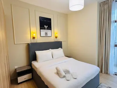 a bedroom with a bed with two towels on it at Celestial 2BR with Burj Khalifa View in Dubai