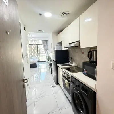 a kitchen with a stove and a dishwasher at An elegant sanctuary in Dubai