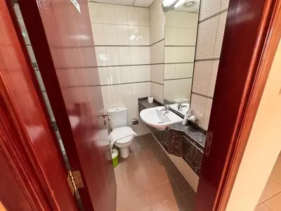 a bathroom with a toilet and a sink at Skylux Bright 1BR with Canal Views & Extra Bed in Dubai