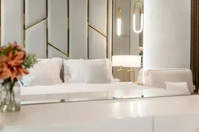 a living room with a white couch and a mirror at Splendid studio on the Palm, infinity pool & private beach in Dubai