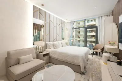 a bedroom with a bed and a chair and a desk at Splendid studio on the Palm, infinity pool & private beach in Dubai