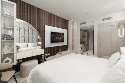 a bedroom with a large white bed and a mirror at Splendid studio on the Palm, infinity pool & private beach in Dubai