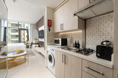 a kitchen with a sink and a stove top oven at Splendid studio on the Palm, infinity pool & private beach in Dubai