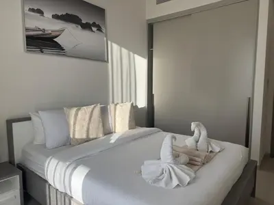 a bedroom with a bed with towels on it at Harmonizing apartment 1BR with a balcony in Grande in Dubai