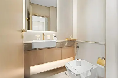 a bathroom with a white toilet and a sink at Luxe 1BR in JVC with Private Jacuzzi & Pool Access in Dubai