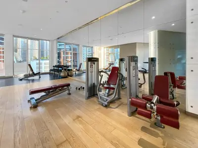a gym with cardio equipment in a building at Luxe 1BR with Balcony & Canal View in Dubai