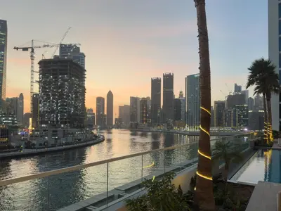 a view of a river with a city in the background at Luxe 1BR with Balcony & Canal View in Dubai