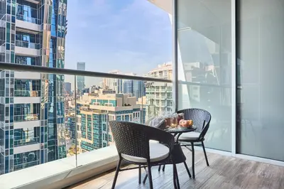 a table and chairs on a balcony with a view at Frank Porter - J One Tower in Dubai