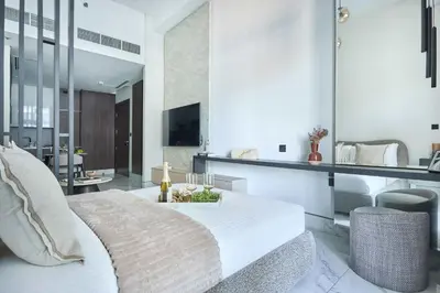 a bedroom with a bed and a living room at Frank Porter - J One Tower in Dubai
