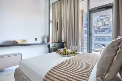 a bedroom with a white bed and a large window at Frank Porter - J One Tower in Dubai