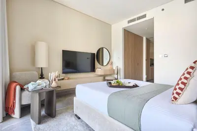 a hotel room with a bed and a tv at Frank Porter - Peninsula One in Dubai