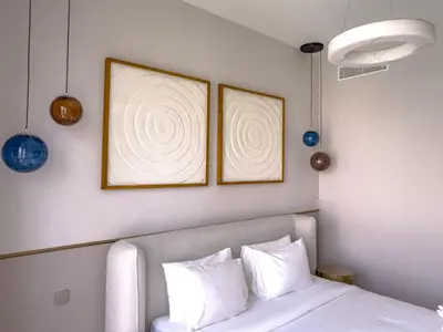 a bedroom with two framed pictures above a bed at GRANDE SIGNATURE RESIDENCES direct Burj Khalifa view and Private Fountain Show at high floor with DXB AIRPORT VIP Shuttle option in Dubai