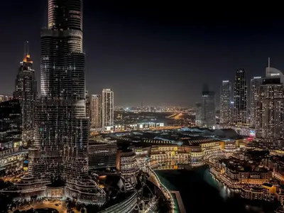 a city skyline at night with tall buildings at GRANDE SIGNATURE RESIDENCES direct Burj Khalifa view and Private Fountain Show at high floor with DXB AIRPORT VIP Shuttle option in Dubai
