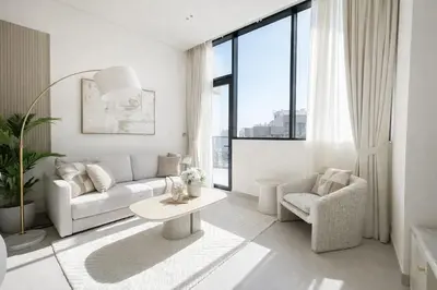 a white living room with a couch and a table at Exclusive 1BR W Private Pool Binghatti Royale in Dubai