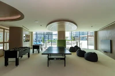 a room with a ping pong table and a game room at Exclusive 1BR W Private Pool Binghatti Royale in Dubai